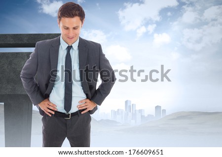 Cheerful businessman standing with hands on hips against unfinished bridge