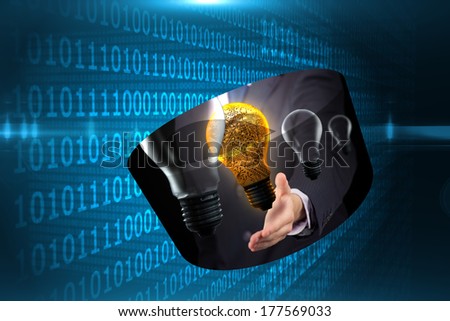 Light bulb graphic on abstract screen against shiny blue binary code on black background