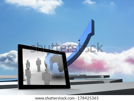 Figures and earth on tablet screen against blue curved arrow pointing up against sky