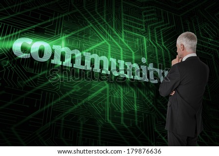 The word community and thoughtful businessman standing back to camera against green and black circuit board