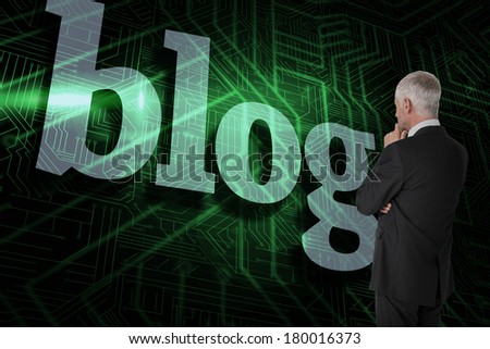 The word blog and thoughtful businessman standing back to camera against green and black circuit board