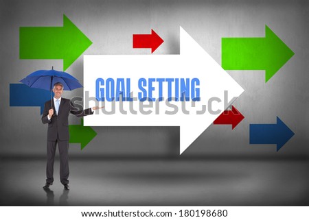 The word goal setting and peaceful businessman holding blue umbrella against arrows pointing