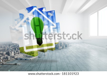 Green light bulb on abstract screen against city scene in a room