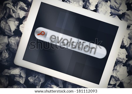 The word evolution in search bar on tablet screen on crumpled papers