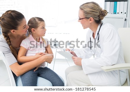 Mother and daughter visiting female doctor in clinic