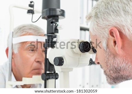 Close-up of an optometrist doing sight testing for senior patient