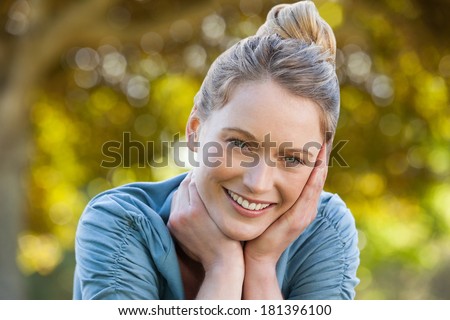 Close-up portrait of a beautiful relaxed young woman at the park