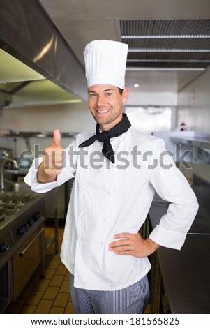 Portrait of a smiling male cook gesturing thumbs up in the kitchen