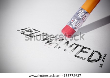 Pencil erasing the word help wanted! on paper