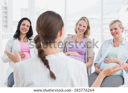 Pregnant women listening to doctor at antenatal class at the hospital