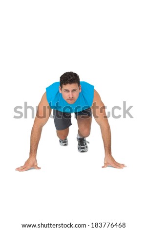 Portrait of a determined young man doing push ups over white background