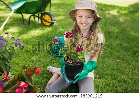 Portrait of a smiling young girl engaged in gardening
