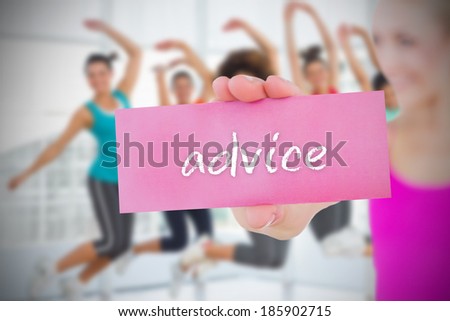 Fit blonde holding card saying advice against  dance class in gym
