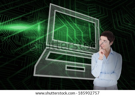 Composite image of laptop and thinking businesswoman against green and black circuit board