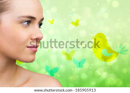 Smiling blonde natural beauty against girly bird and butterfly design