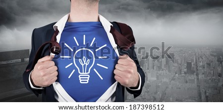 Businessman opening his shirt superhero style against gloomy city