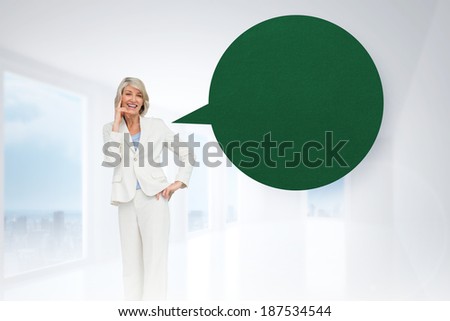 Thinking businesswoman with speech bubble against bright white hall with columns