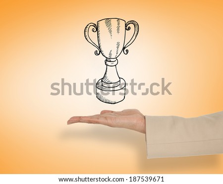 Female hand presenting winners cup against orange vignette