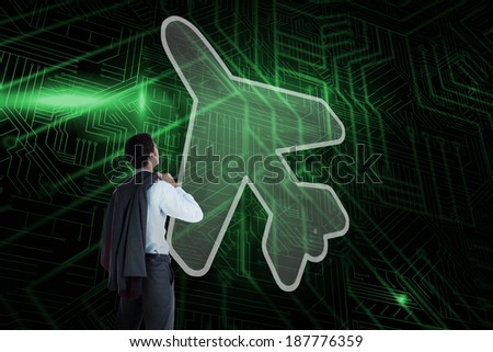Composite image of airplane and businessman looking against green and black circuit board