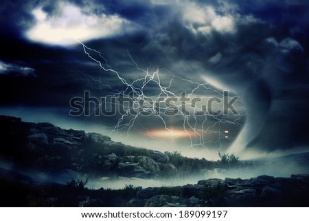 Digitally generated stormy sky with tornado over landscape
