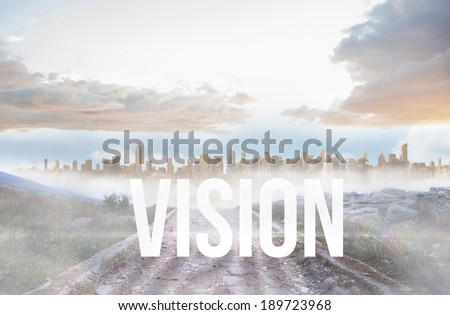 The word vision against rocky path leading to large urban sprawl