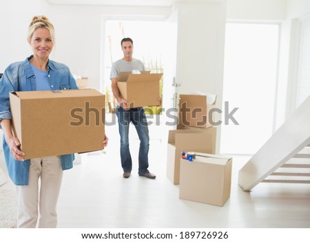 Portrait of a smiling couple moving together in a new house