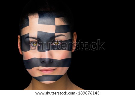 Composite image of greek football fan in face paint against black
