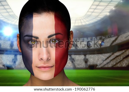 Composite image of beautiful france fan in face paint against vast football stadium with fans in blue