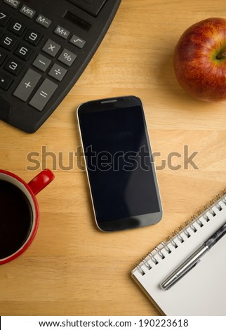 Overhead of smartphone with calculator on a desk