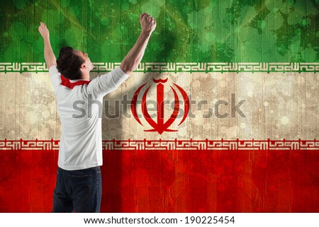 Excited football fan cheering against iran flag in grunge effect