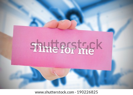 Woman holding pink card saying time for me against fitness class in gym