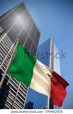 Italy national flag against low angle view of skyscrapers