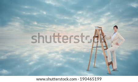 Smiling businesswoman climbing the career ladder against clouds reflected on water