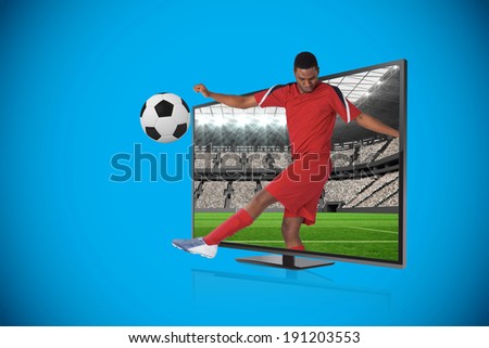 Composite image of football player kicking ball through tv against vast football stadium with fans in white