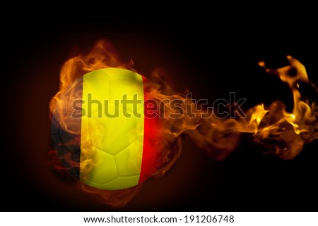 Composite image of fire surrounding belgium ball against black