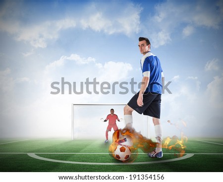 Composite image of football player about to take a penalty against football pitch under blue sky