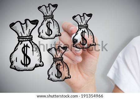 Composite image of businesswoman drawing money bags against grey vignette