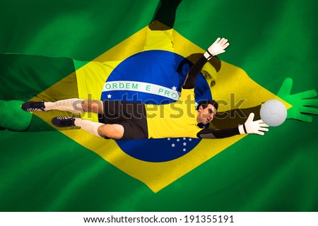 Goalkeeper in yellow making a save against digitally generated brazilian national flag