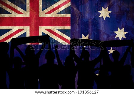 Silhouettes of football supporters against australia flag in grunge effect