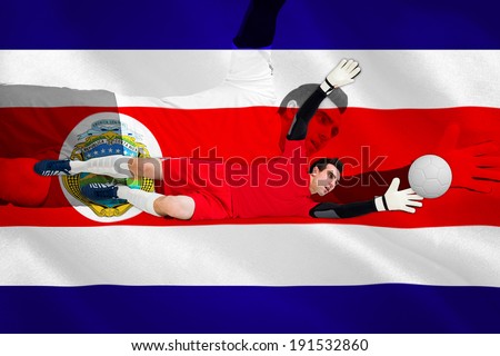 Goalkeeper in red making a save against costa rica national flag