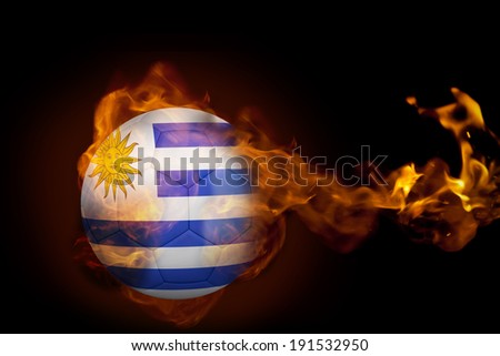 Composite image of fire surrounding uruguay ball against black