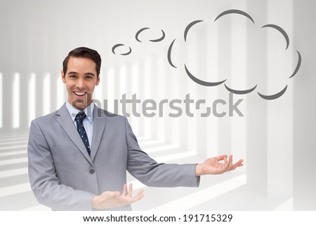 Young businessman presenting something with thought bubble against curved white room