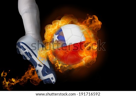 Football player kicking flaming chile ball against black