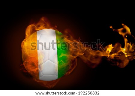 Composite image of fire surrounding ivory coast ball against black