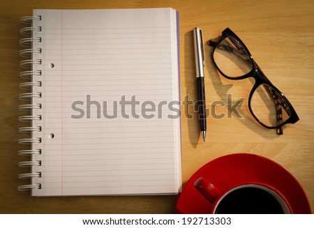 Overhead of notepad and pen on a desk