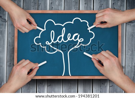 Composite image of multiple hands drawing idea tree with chalk on wooden board
