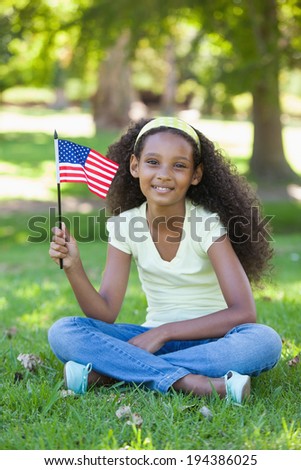 Young girl celebrating independence day in the park on a sunny day