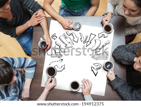 People sitting around table drinking coffee with page showing arrows