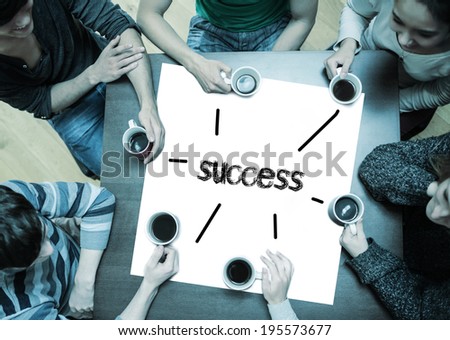 The word success on page with people sitting around table drinking coffee