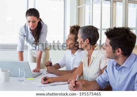 Business people using laptops and notebooks in meeting in the office